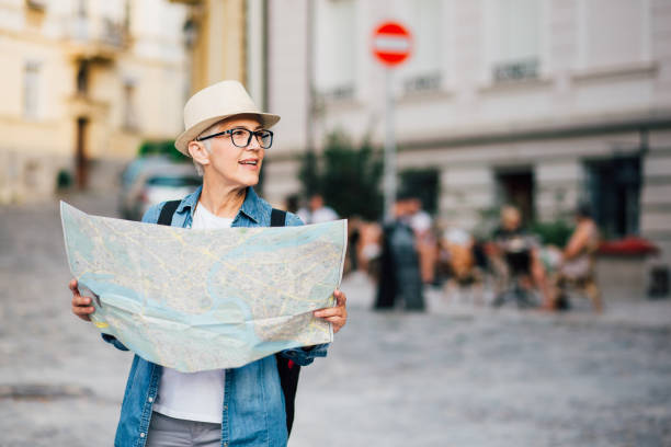 istock Tourist woman holding the map 1209552466