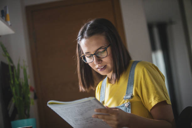 istock Young woman studying at home 1209553607