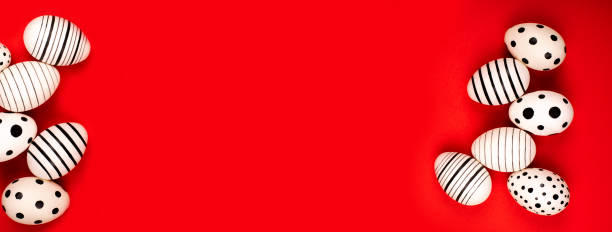 istock Banner made of different graphic hand-painted eggs on bright red background. 1209553825
