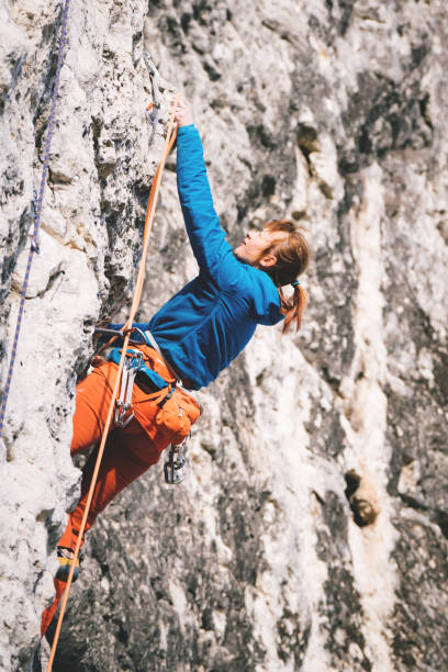 istock Woman climbs a rock. 1209553857