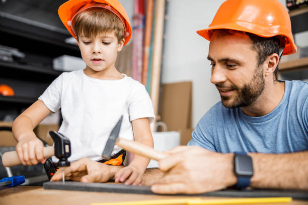 istock Happy carpenter is teaching son stock photo 1209555281