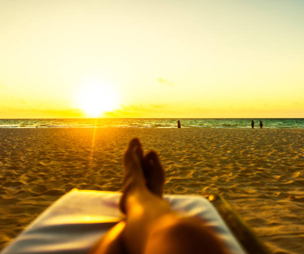 POV Man relaxing on the beach alone in the morning