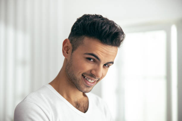 istock Happy young man is posing in room 1209560642