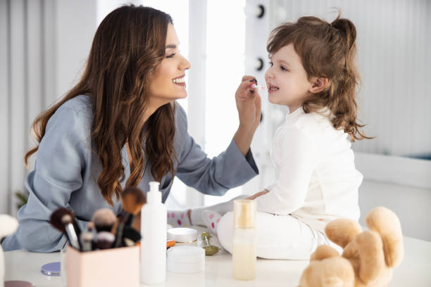 istock Smiling mother brushing her little daughter teeth 1209568540