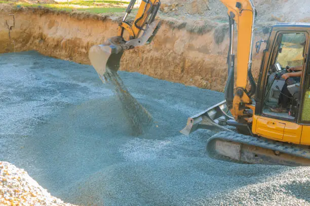 Photo of A excavator in a working to gravel construction equipment for foundation construction.