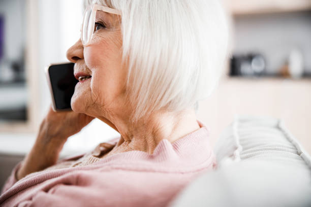 istock Senior woman talking on cellphone and smiling 1209575165
