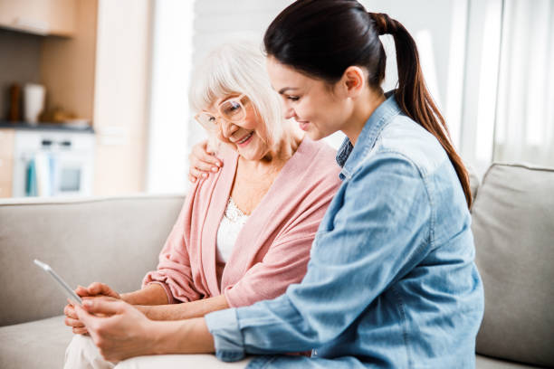 istock Grandmother and granddaughter using modern digital tablet 1209575224