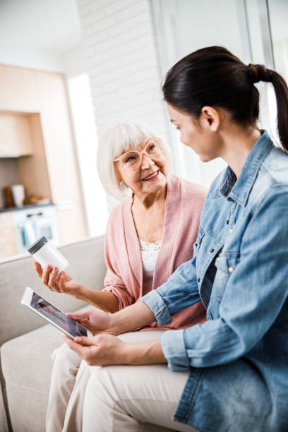 istock Old lady discussing medicaments with daughter and doctor 1209575237