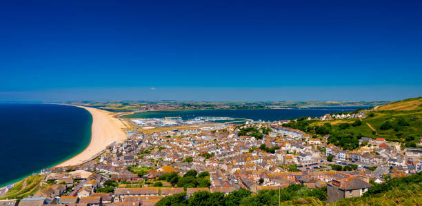 Chesil Beach, Portland Harbour and Weymouth Chesil Beach and Portland Harbour with Fortuneswell on a summer day weymouth dorset stock pictures, royalty-free photos & images