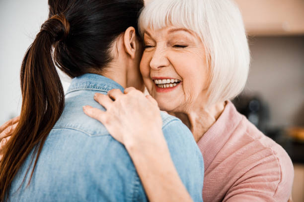 istock Cheerful elderly woman hugging granddaughter and smiling 1209577413