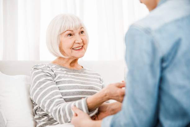istock Cheerful elderly woman lying in bed at home 1209577430