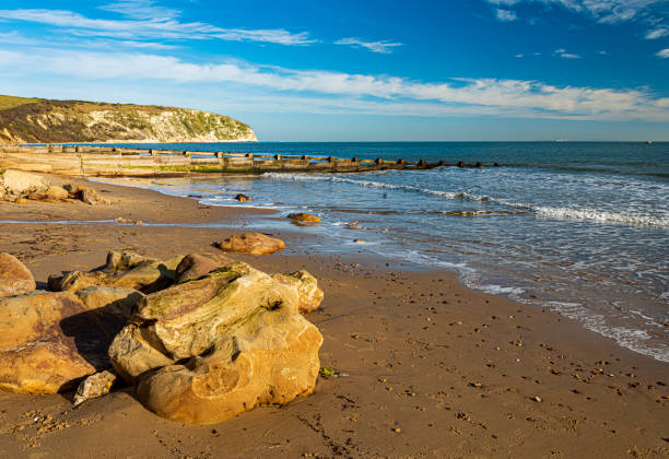 istock Swanage beach and rocks with in-coming tide 1209579093