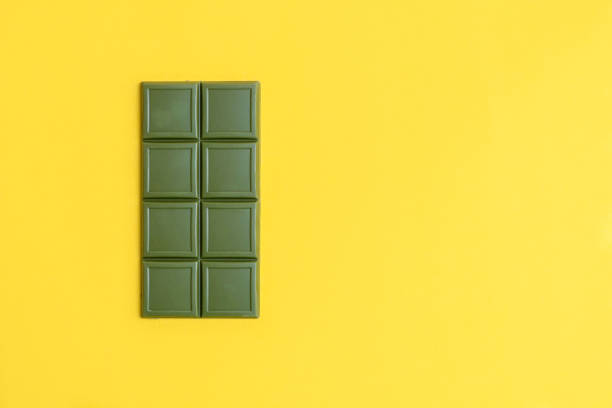 istock Healthy matcha green tea chocolate on yellow background 1209579187