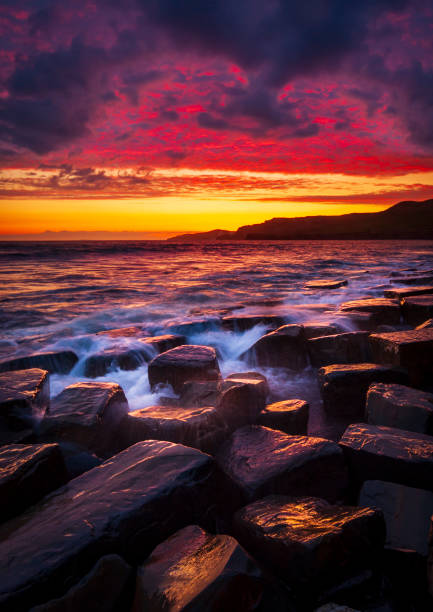 istock Kimmeridge sunset - rain clouds clear to reveal red skies 1209581071