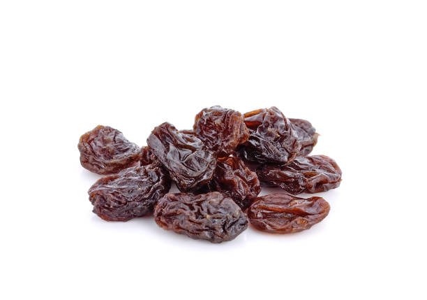 Dried raisins on white Dried raisins on white background raisin stock pictures, royalty-free photos & images