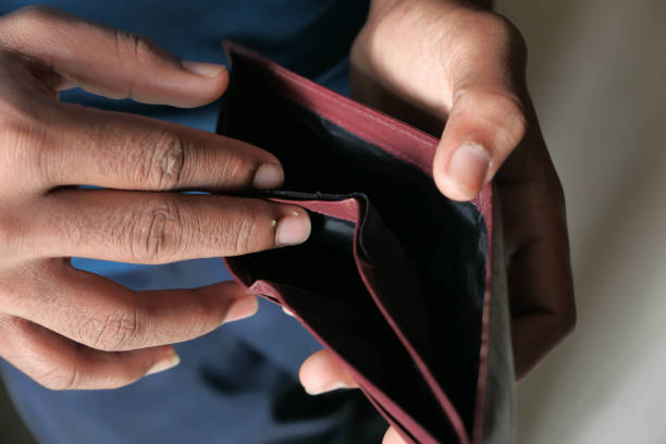 istock Close up of man hand holding empty wallet 1209591387