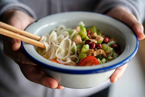 Chinese homemade noodles: broth noodles with cucumber and chicken meat dices