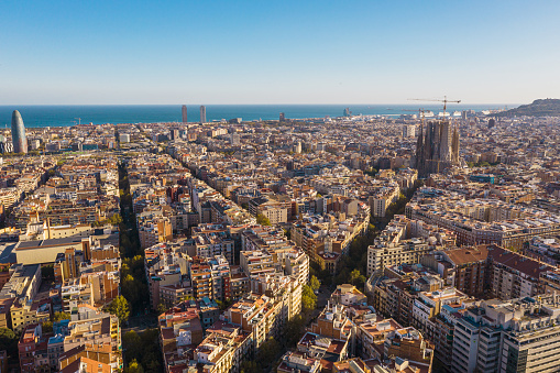 Drone aerial view of famous straight down view, Eixample streets and old tradition buildings and street trafic, beautiful famous urban grid pattern in Spain.