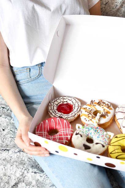 istock Female hand holding delicious donut 1209602388