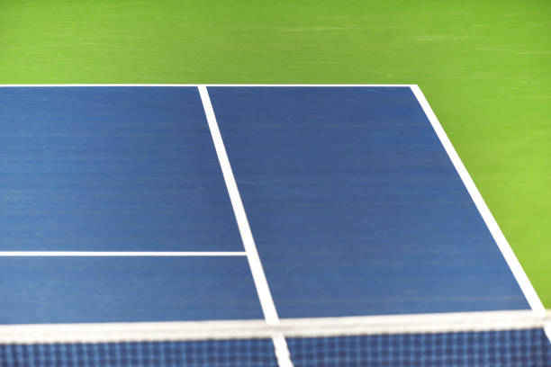 White lines on blue tennis court stock photo