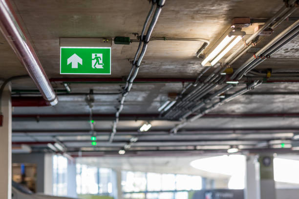 istock Green emergency exit sign showing the way to escape.Fire exit in the building. 1209603076