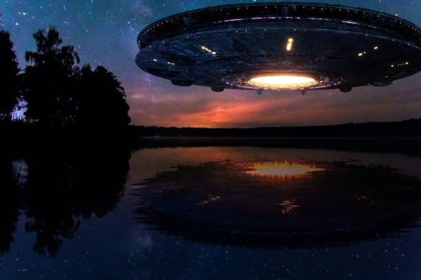 istock UFO, an alien plate hovering above water, hovering motionless in the air. Unidentified flying object, alien invasion, extraterrestrial life, space travel, humanoid spaceship. mixed medium 1209611606