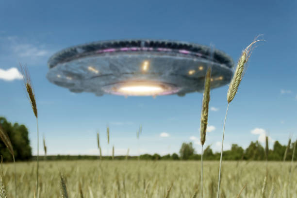 istock UFO, an alien plate hovering over the field, hovering motionless in the air. Unidentified flying object, alien invasion, extraterrestrial life, space travel, humanoid spaceship. mixed medium 1209611751