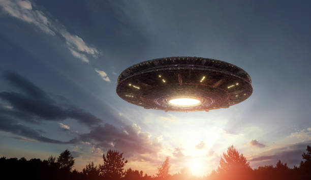 istock UFO, an alien plate hovering over the field, hovering motionless in the air. Unidentified flying object, alien invasion, extraterrestrial life, space travel, humanoid spaceship. mixed medium 1209611755
