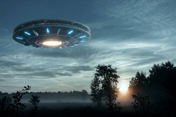 istock UFO, an alien plate hovering over the field, hovering motionless in the air. Unidentified flying object, alien invasion, extraterrestrial life, space travel, humanoid spaceship. mixed medium 1209611766