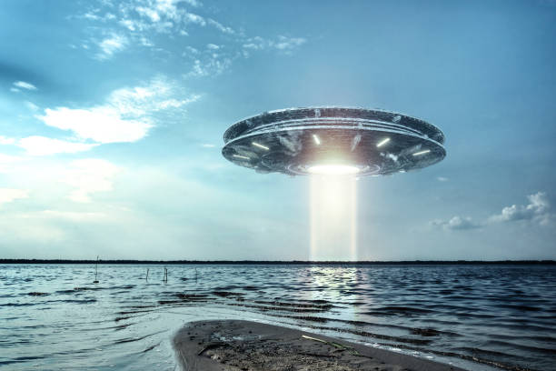 istock UFO, an alien plate hovering above water, hovering motionless in the air. Unidentified flying object, alien invasion, extraterrestrial life, space travel, humanoid spaceship. mixed medium 1209611767