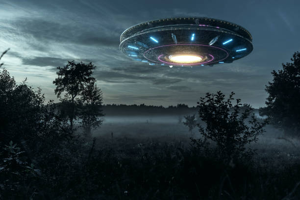 istock UFO, an alien plate hovering over the field, hovering motionless in the air. Unidentified flying object, alien invasion, extraterrestrial life, space travel, humanoid spaceship. mixed medium 1209611771