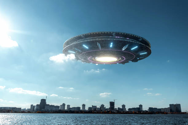 istock UFO, an alien plate hovering above water, hovering motionless in the air. Unidentified flying object, alien invasion, extraterrestrial life, space travel, humanoid spaceship. mixed medium 1209611777
