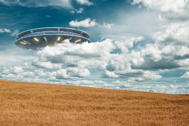 istock UFO, an alien plate hovering over the field, hovering motionless in the air. Unidentified flying object, alien invasion, extraterrestrial life, space travel, humanoid spaceship. mixed medium 1209611781