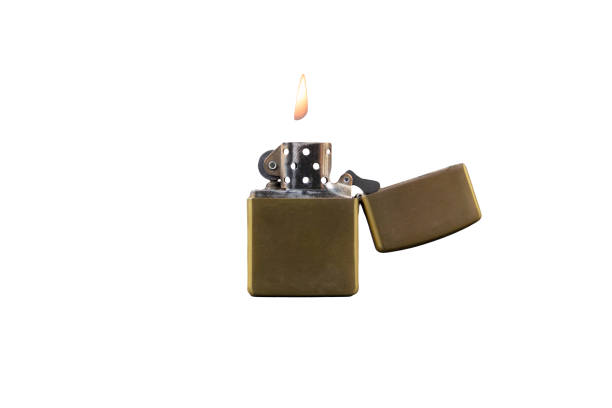 istock Golden brass metal gasoline lighter with fire. isolated on white 1209612517
