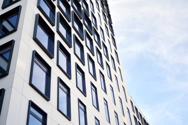 istock Modern European building. White building with many windows against the blue sky. 1209615368