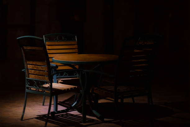 istock Table with chairs in a cafe on the street at night 1209618061