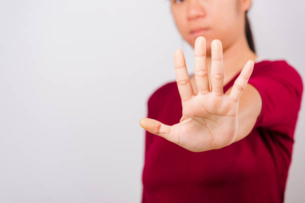 istock Asian beautiful woman itching her outstretched hand showing stop gesture front face, focus on hand 1209619796