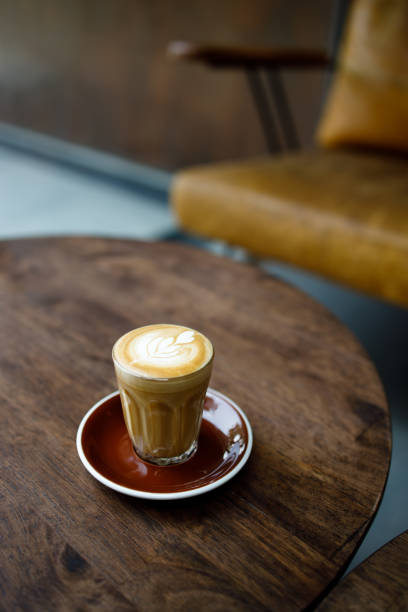 istock small cup of coffee with heart pattern froth on wooden table 1209623930