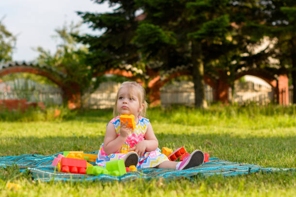 Child playing whit toy block outdoors