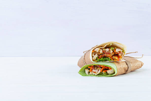 istock Delicious shawarma sandwich with chicken on wooden background 1209627444