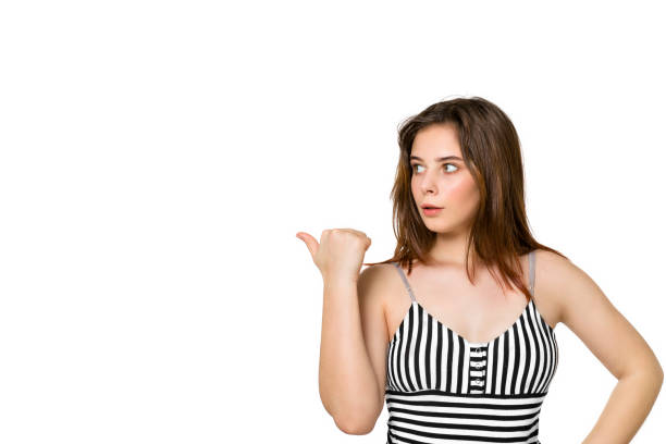 istock Young brunette looking surprised shows back in disbelief, saying wow, unbelievable on white background 1209628375
