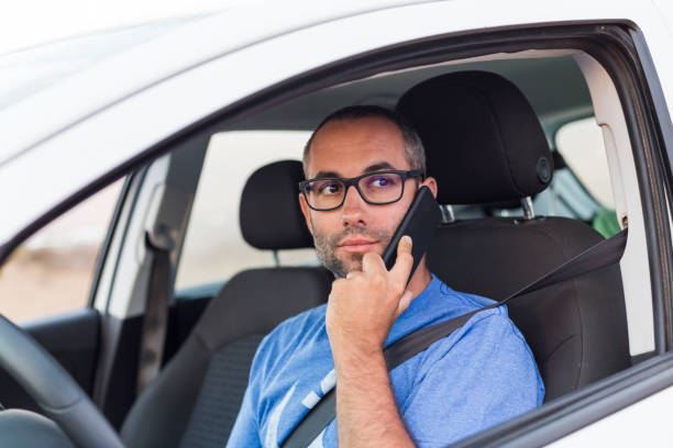 istock handsome man talking on his mobile phone in the car. lifestyle 1209629994