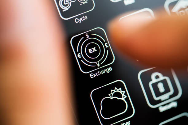 istock Currency exchange app on dark mode phone screen 1209631183