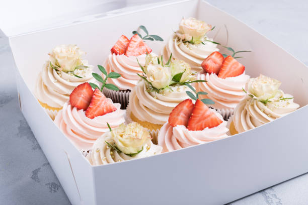 istock cupcakes decorated with fresh flowers and fresh strawberries 1209631281