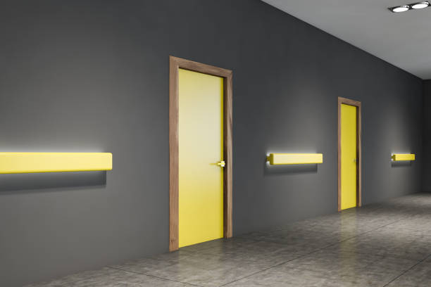 istock Empty office corridor with yellow doors 1209632468