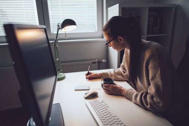 istock Young woman working at her home office 1209633400