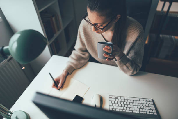 Young woman working long hours at her home office