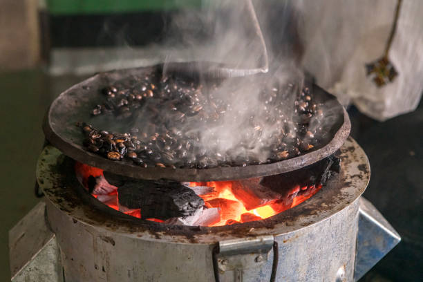 Roasting of coffee beans on a flat pan in a house in southern Ethiopia