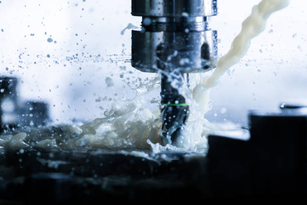 istock a process of vertical cnc steel milling with external water coolant streams, splashes and a lot of metal chips, high contrast 1209636967