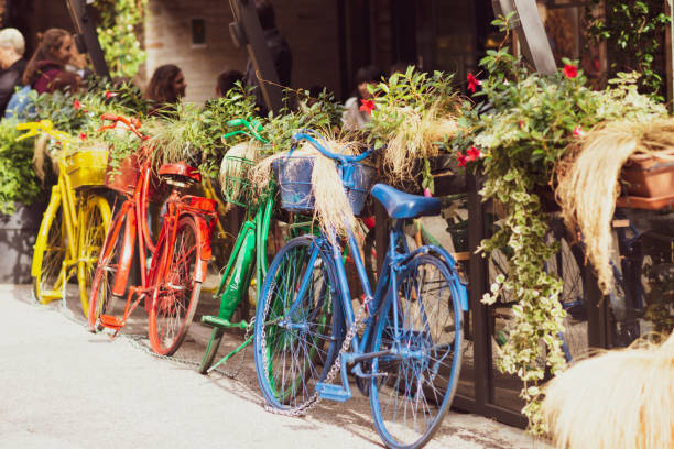 painted bycicles parked on the sideway, outdoor photo - ravena imagens e fotografias de stock